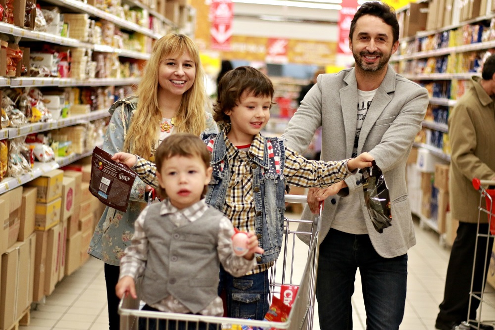 happy family shopping for food in a supermarket